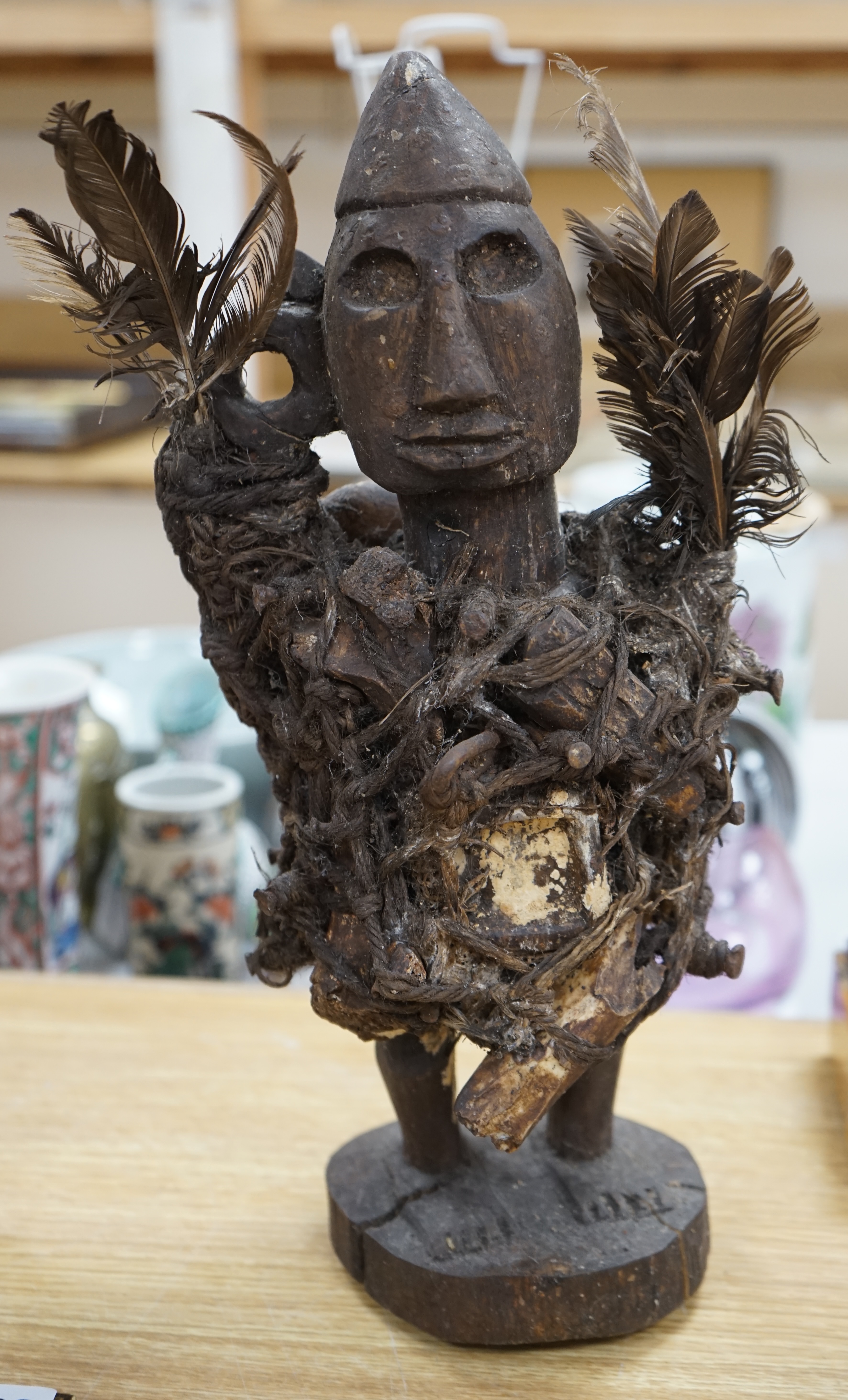 A Congo wood, feather and bone fetish figure, 39cm high. Condition - fair